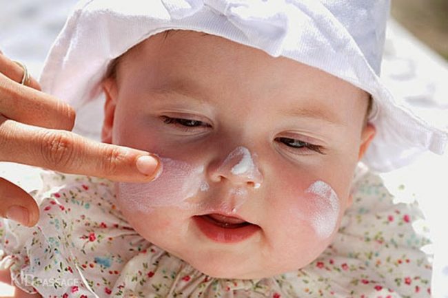 Нанесение солнцезащитного крема на лицо малыша