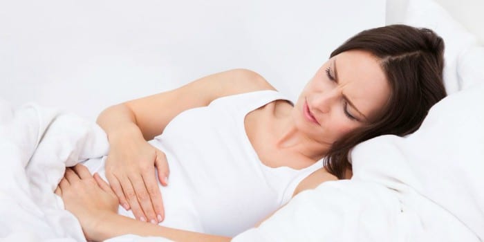 Беременная женщина лежит на кровати